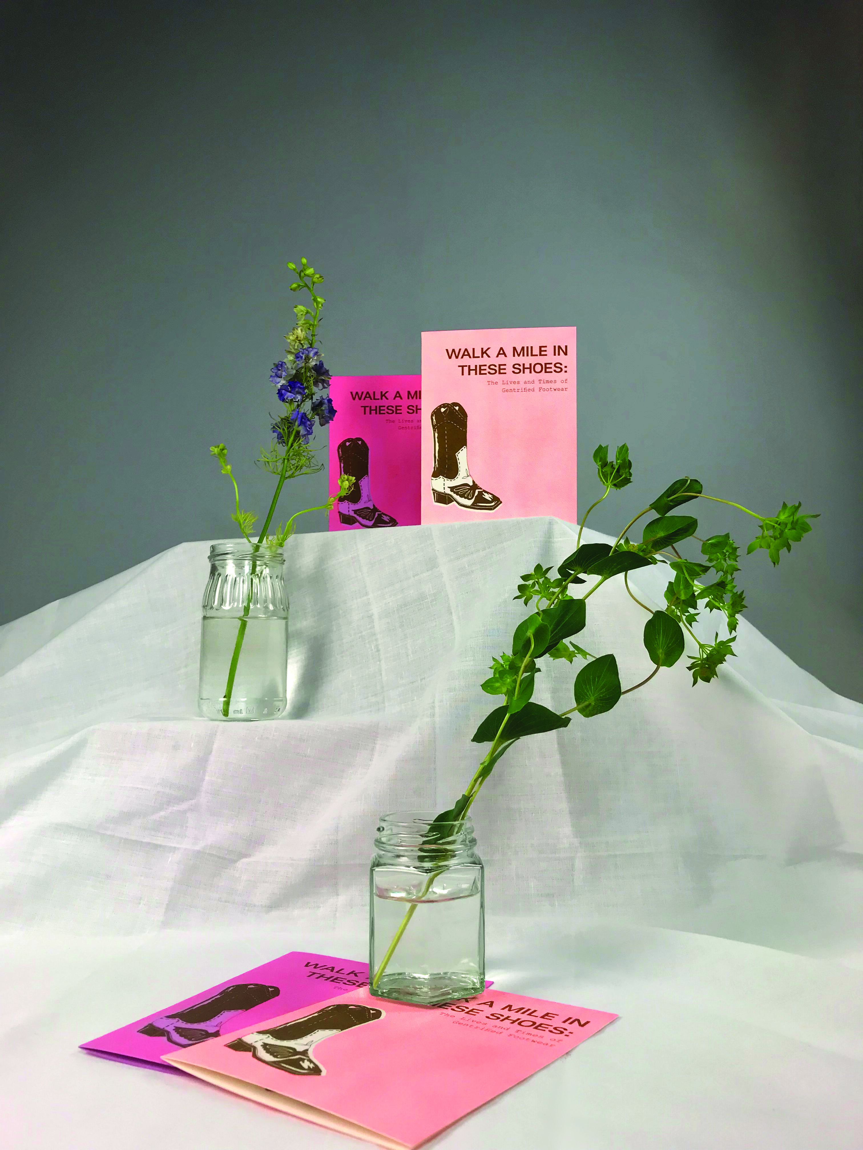 shoe zines displayed with vines and flowers at different heights.